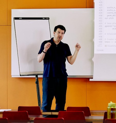 Patrick Mello teaching in front of a whiteboard